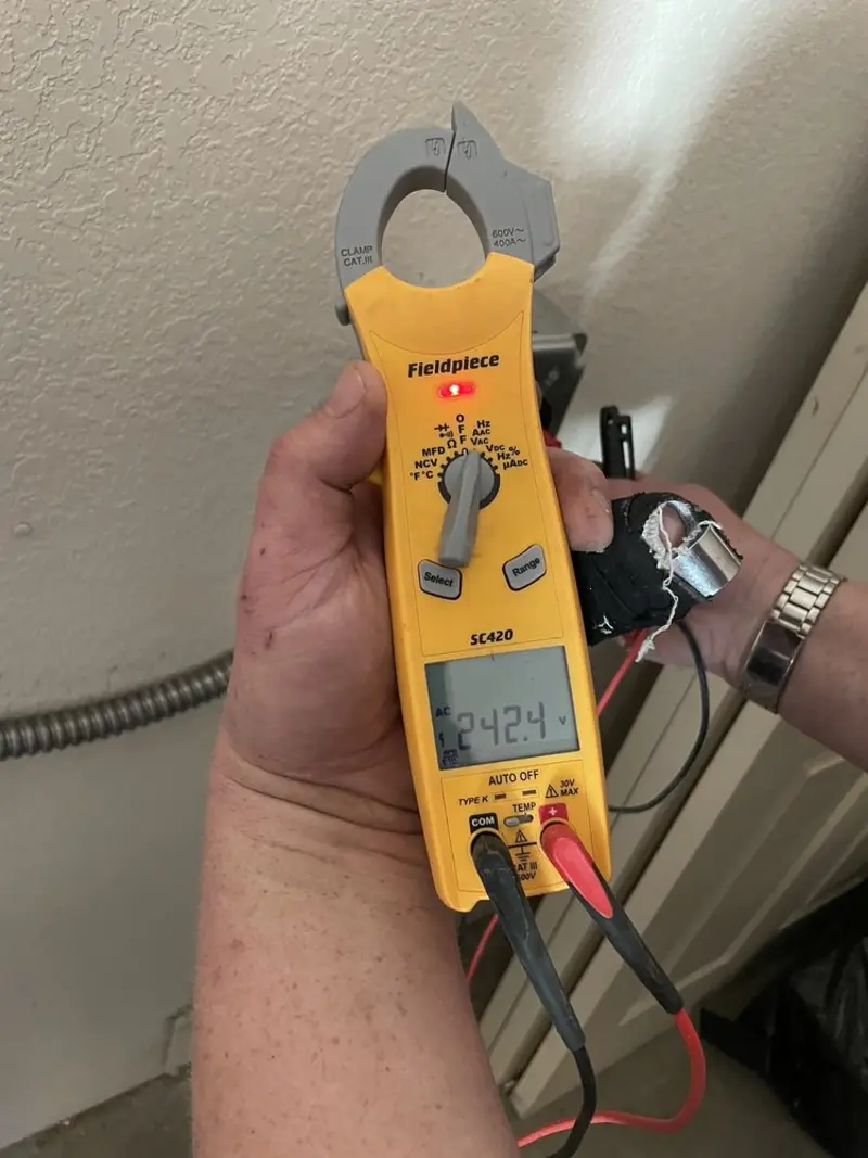 Voltage testing with clamp meter during Recessed Lighting Installation in Peru